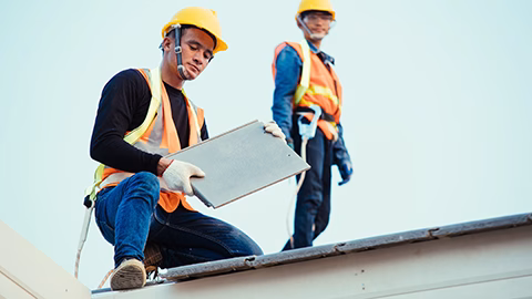 Engineer wear safety uniform inspection installing new roof of modern house.